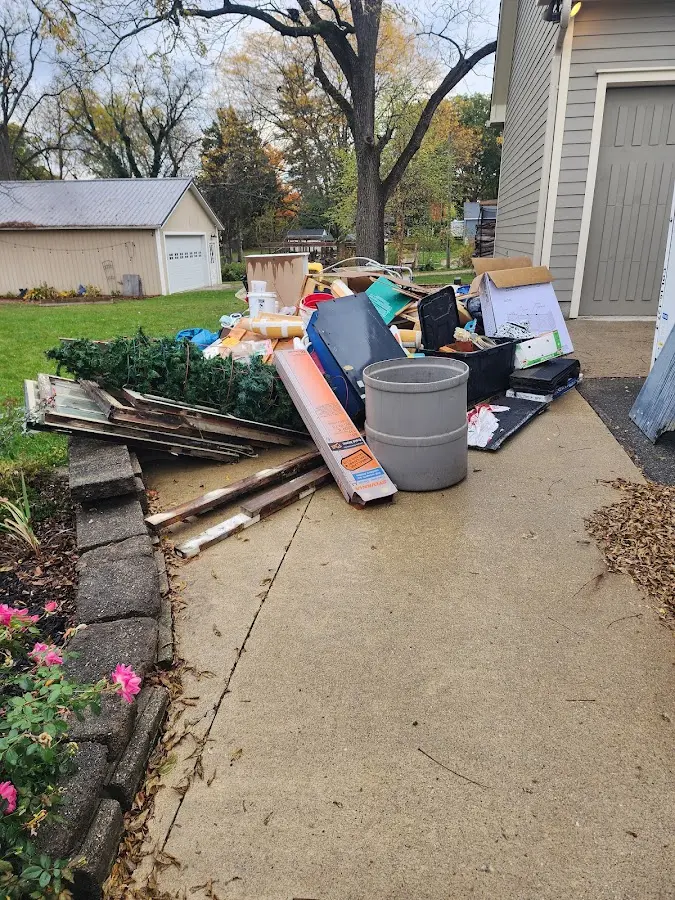 Dumpster being loaded with debris for 10 Yard Dumpster Rental in Hominy